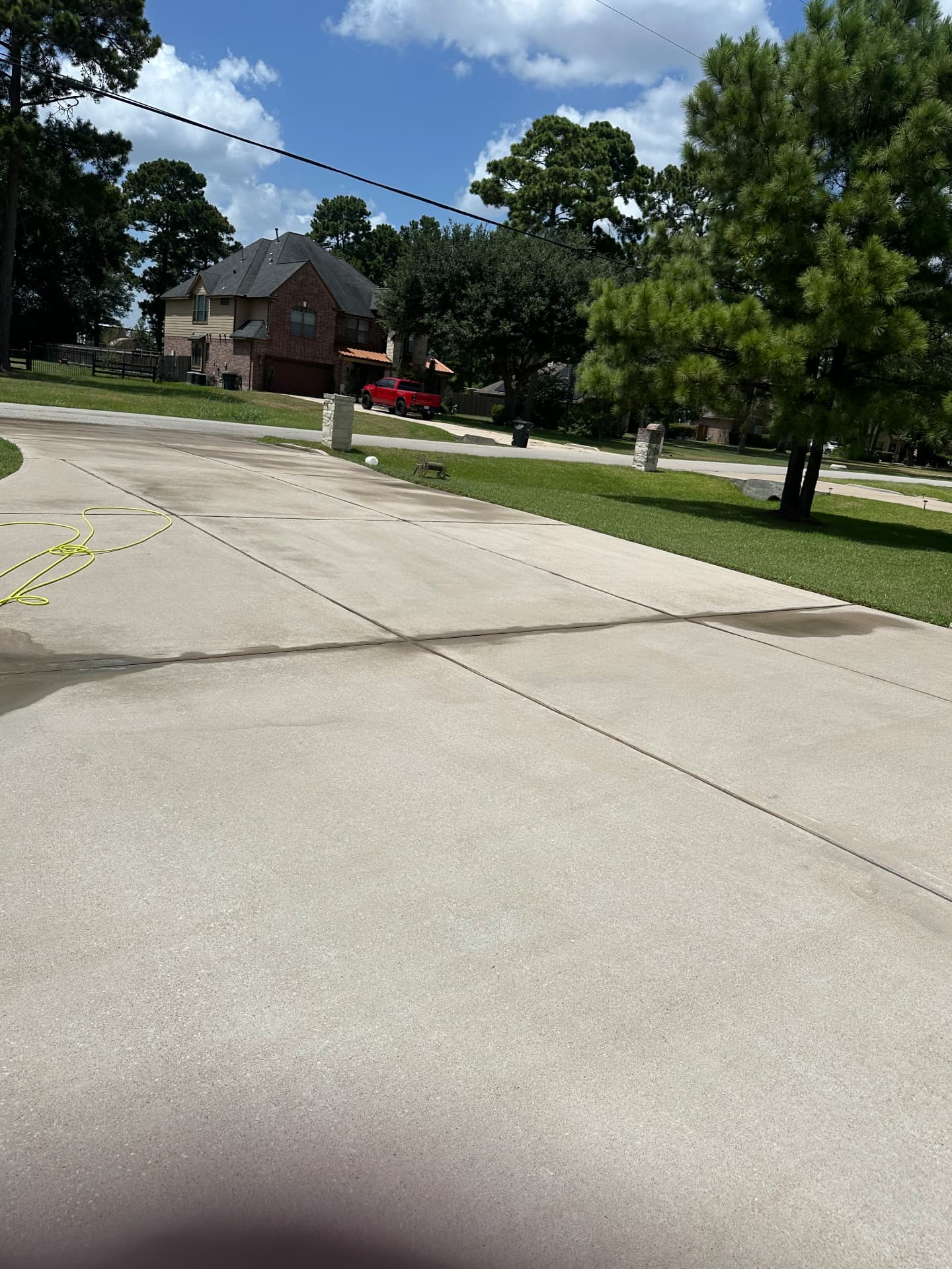 Clean bright concrete driveway after pressure washing in Katy TX