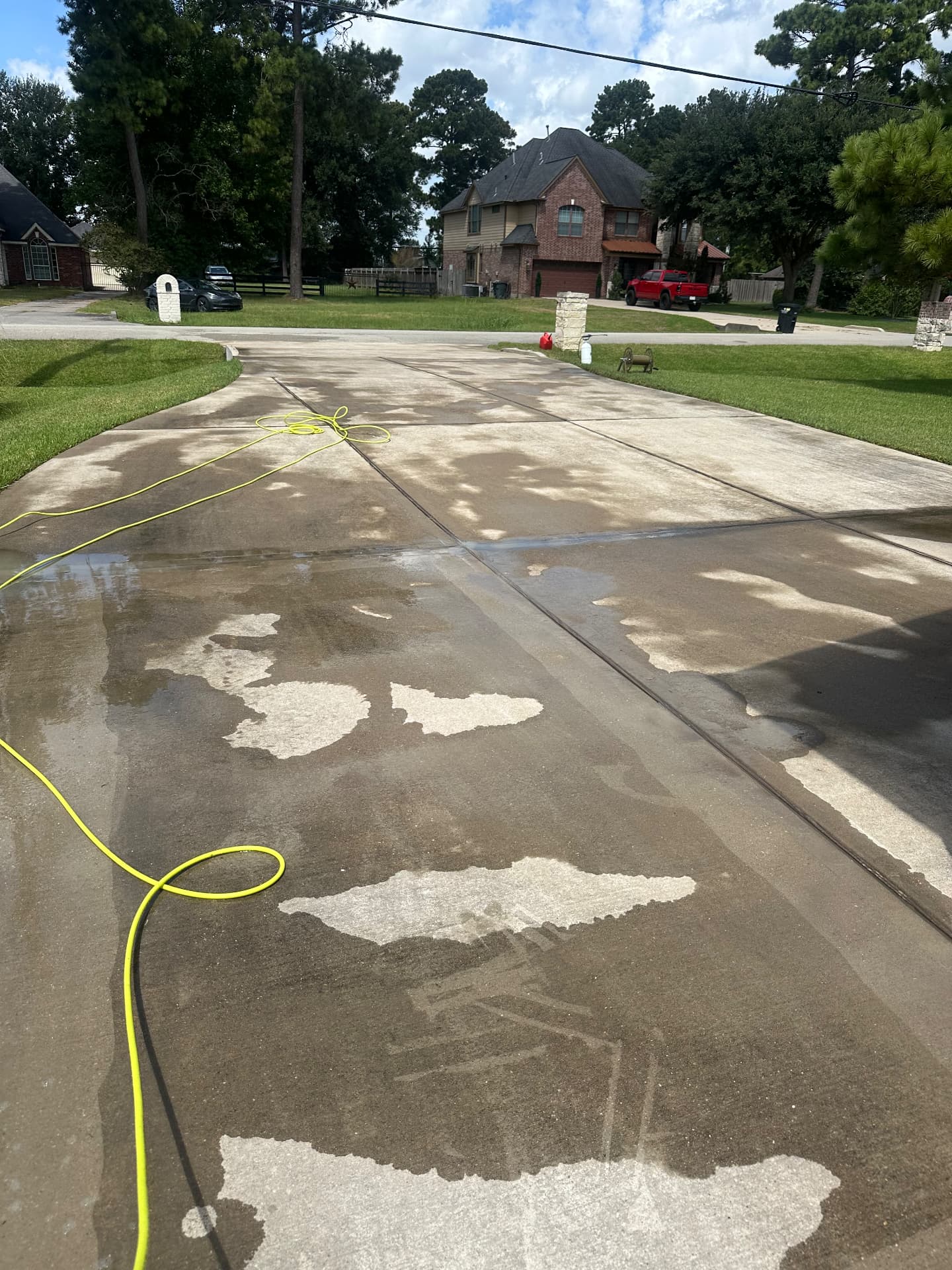 Dirty stained concrete driveway before pressure washing in Katy TX
